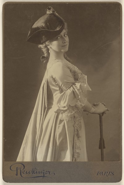 woman wearing a dark hat, standing, with hands resting on a walking stick; Emile Auguste Reutlinger, French, 1825 - 1907