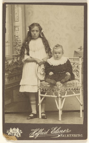 girl with long hair, standing, and a baby girl, seated; Evie Helfrid Elsner, Swedish, 1867 - 1937, about 1900; Platinum print