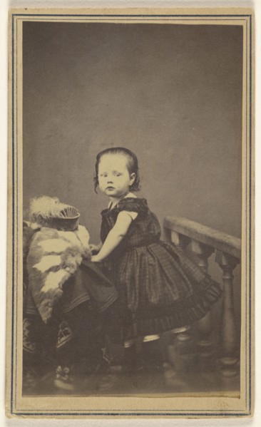 little girl standing, leaning on a prop in a studio; S. Bruckner; 1865 - 1870; Albumen silver print