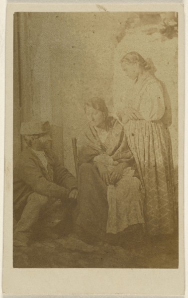 Woman seated holding a baby, a man and woman on either side; 1865 - 1870; Albumen silver print