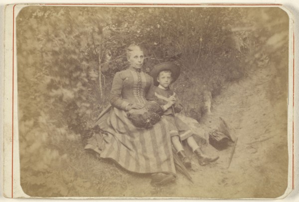 Woman seated on the ground with an boy; 1865 - 1875; Albumen silver print