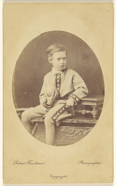 boy holding a ball, seated on an ornately carved table; Robert Faulkner, British, active 1860s - 1880s, 1865-1875; Albumen