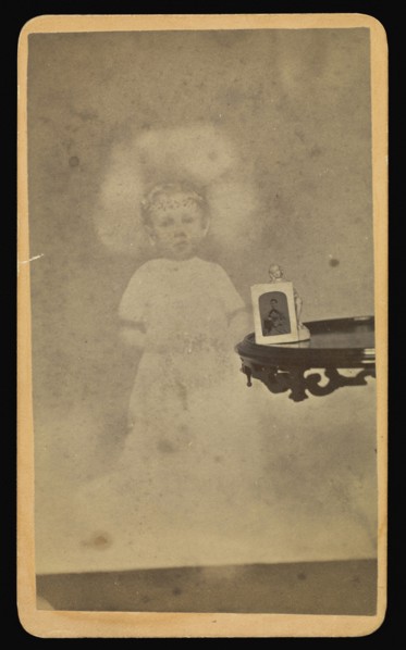 Child  spirit  with photograph and figurine on table; William H. Mumler, American, 1832 - 1884, Boston, Massachusetts, United