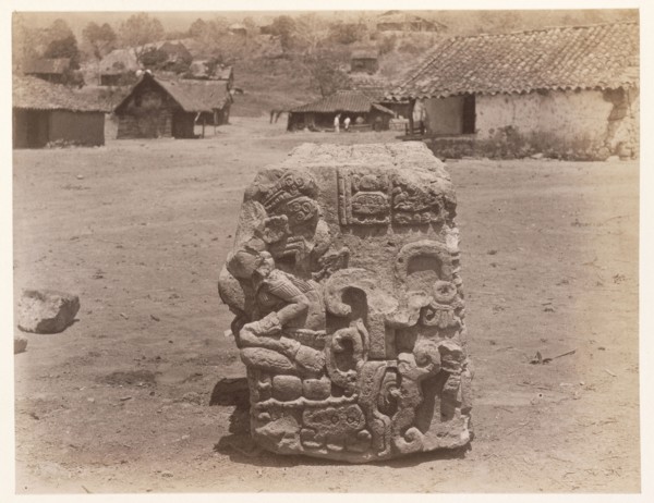 Carved block, with village buildings in background, Edmund Lincoln miscellaneous papers relating to the excavation of Maya ruins