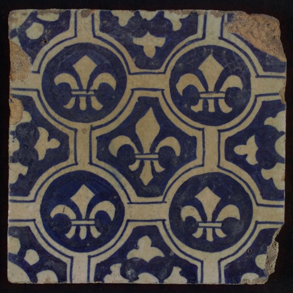 Two-tone tile, blue on white background, four circles with white French lily around central ornament with lily, wall tile