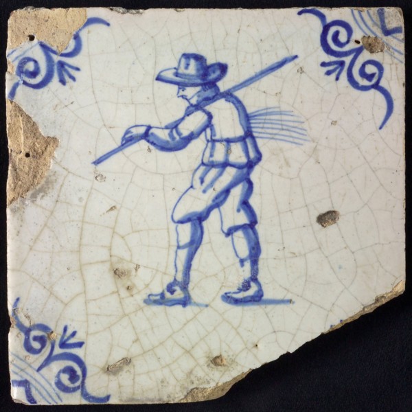 Figure tile, blue with farmer with stick and forest straw, corner motif oxen head, wall tile tile sculpture ceramic earthenware