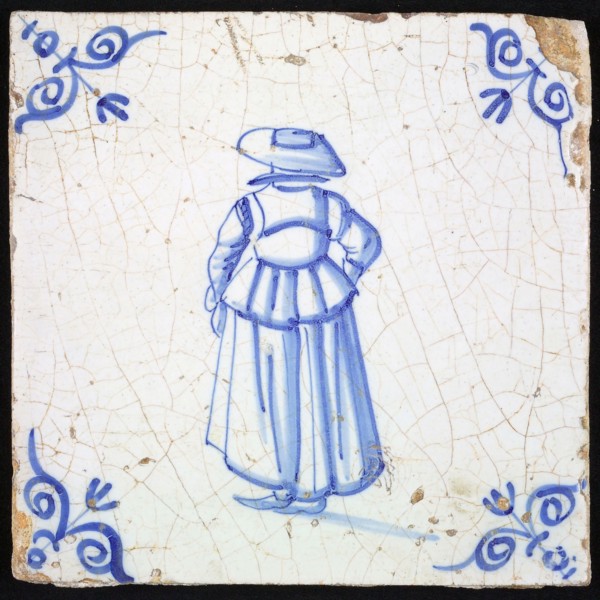 Figure tile, blue with lady with big hat, seen on the back, corner motif ox's head, wall tile tile sculpture ceramic earthenware