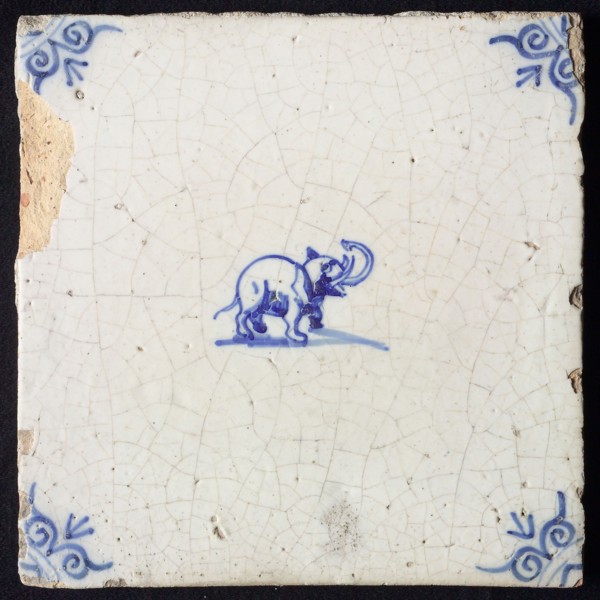 Animal tile, standing elephant to the right, in blue on white, corner motif of ox's head, wall tile tile sculpture ceramic