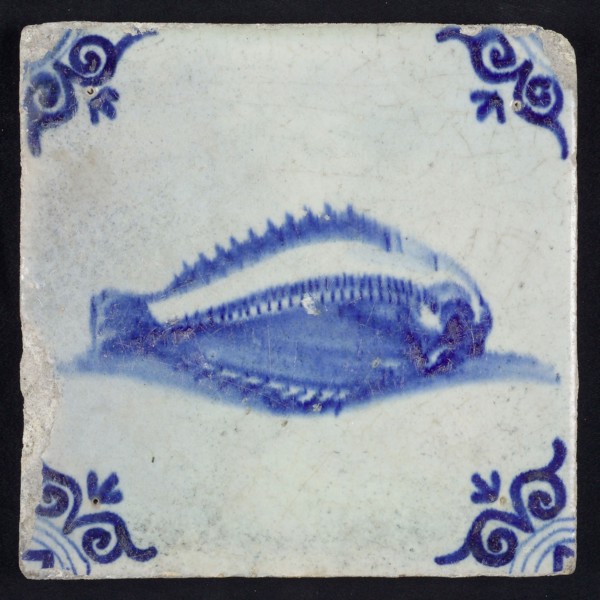 Animal tile, unknown fish in water to the right, in blue on white, corner motif of ox's head, wall tile tile sculpture ceramic