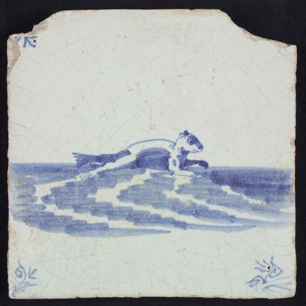 Animal tile, sea-washed in continuous water to the right, in blue on white, corner motif of ox-head, wall tile tile sculpture