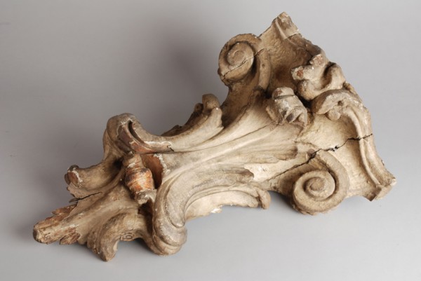 Carved wooden console from the façade of house, console building element carvings sculpture visual material wood gypsum paint