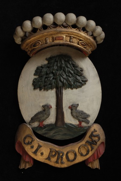 Carved wooden crowned coat of arms including the name G.I. Proons, coat of arms information form wood carving sculpture