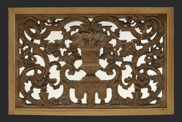 Skylight with an antique vase of wood carved in wood, surrounded by leaves, flowers and garlands, cutting window toplight