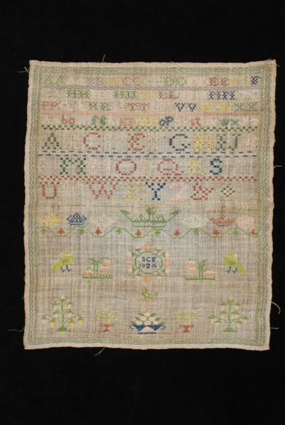 Sampler or letterlap worked in cross stitch in colored silk on loosely woven linen, marked SCF 1824, lettercloth sampler
