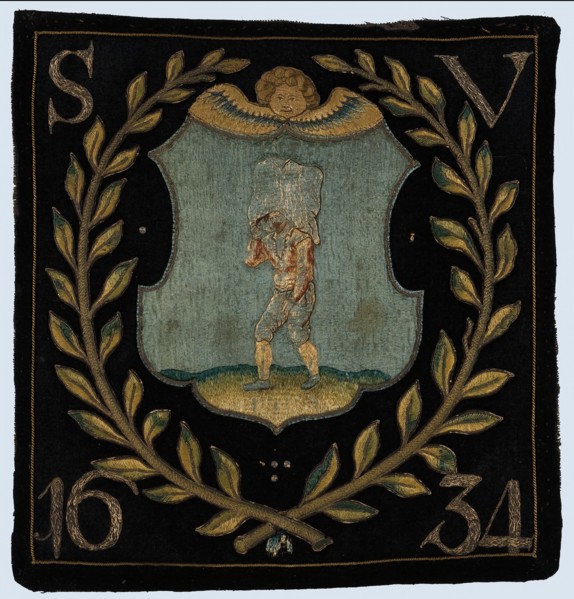 Blazon of black cloth with application depicting bag carrier, blazon coat of arms information form wool cotton linen burlap