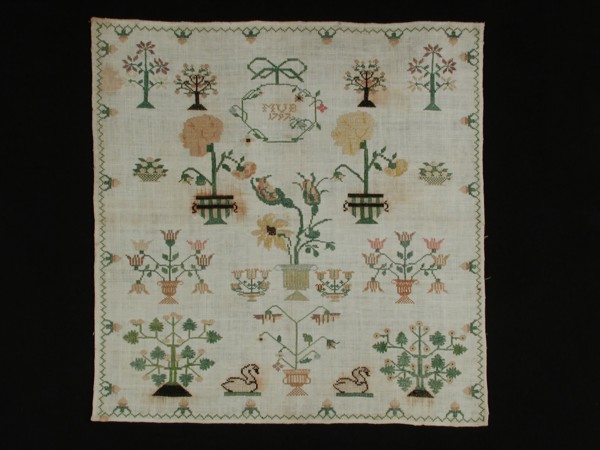 Sampler worked in cross stitch in colored silk on cream cotton with linen effect, marked MUB 1797, merklap embroidery needlework