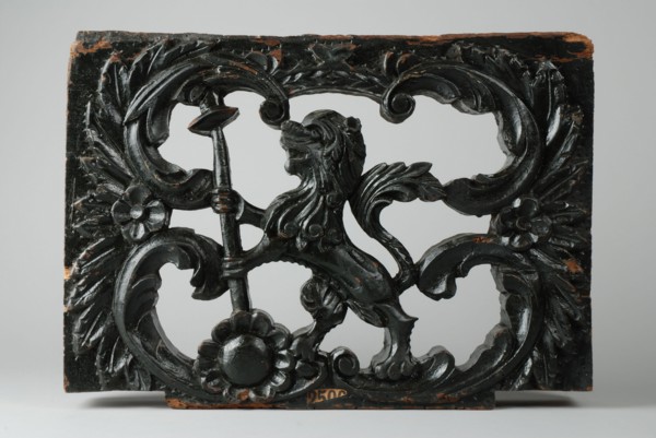Ornament of wagon, carved lion with spear and hat, ornament part woodcarving sculpture sculpture wood paint, Ornament
