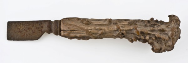 Knife with iron blade and legs raises with capriciously carved decoration, knife cutlery soil find iron bone metal, archeology