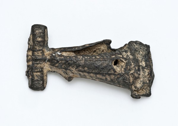 Tin flute or artefact with simple relief decoration, artifact soil find tin metal, cast Pointed object of tin. Decorated