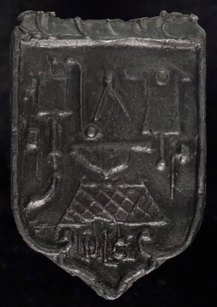 Roof bonnet, shield-shaped cover plate with guide tools and initials, bollard bar seal ground find lead metal, Roof bonnet
