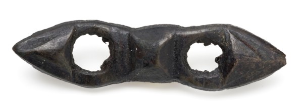 Elongated bronze fittings with two round openings, clothing accessory clothes batter ground find bronze copper metal, cast