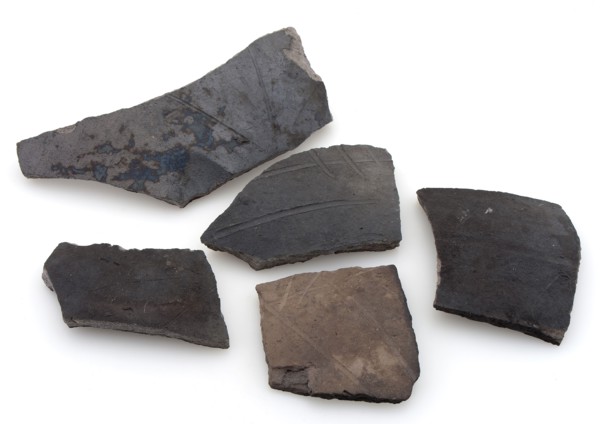 Fragments of cooking pots, dark earthenware, decorated with incised lines, cooking pot crockery holder kitchen utensils fragment