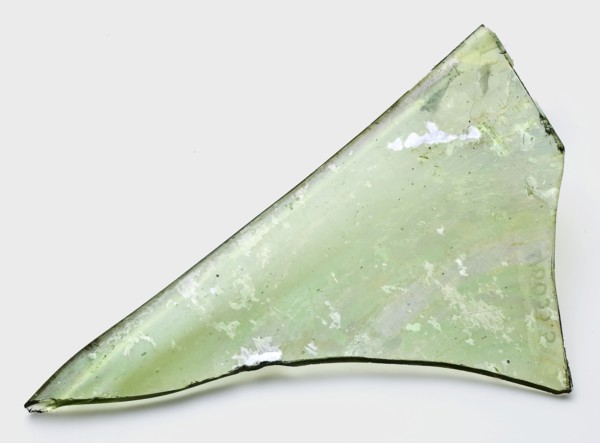 Fragment of window pane, glass soil found glass, hand-blown Fragment of window pane in clear green glass Edge curved up