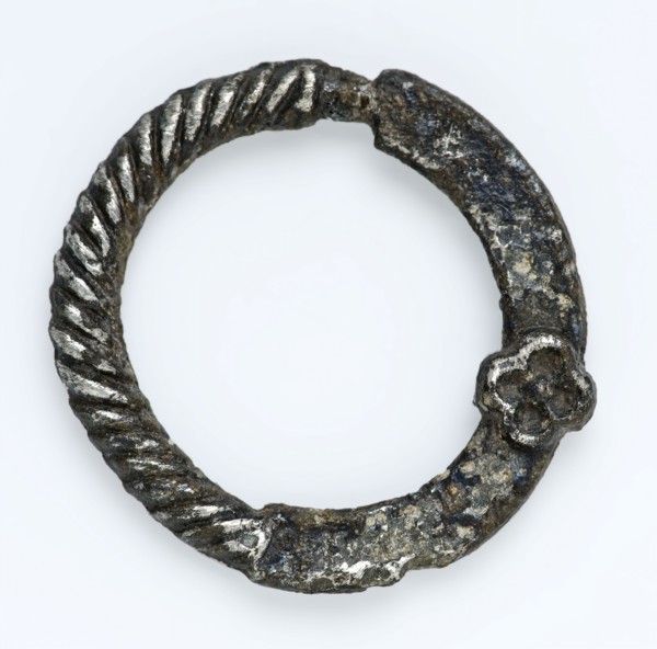 Annular buckle with twisted edge and small rosette, ornamental buckle, buckle fastener component soil find tin? silver? metal