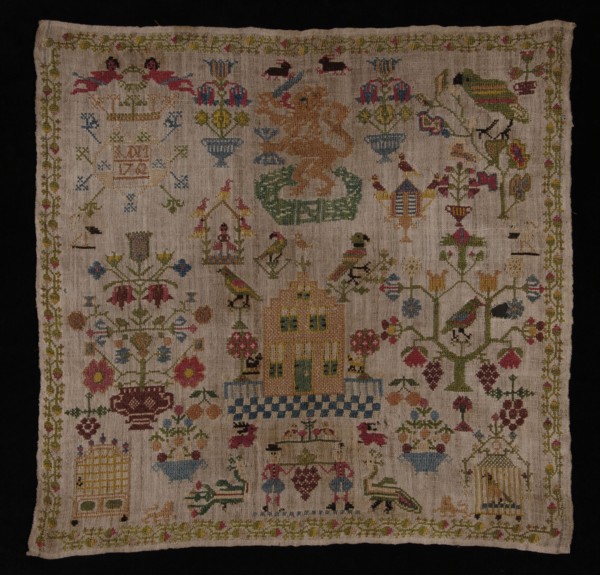 Trademark worked in cross-stitch with colored silk on loosely woven cream-colored linen, IVDM 1762, sampler embroidery