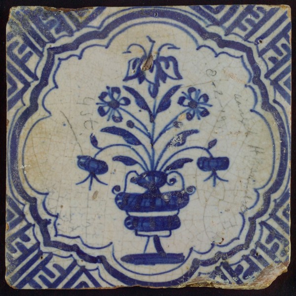 Tile with blue pot with flowers in brace-like frame; corner pattern meander, wall tile tile sculpture ceramic earthenware glaze