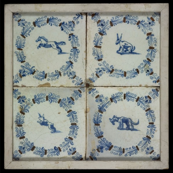 Tile field, four tiles with animal decor, blue and brown on white, one with horse and three others with dog, all in egret