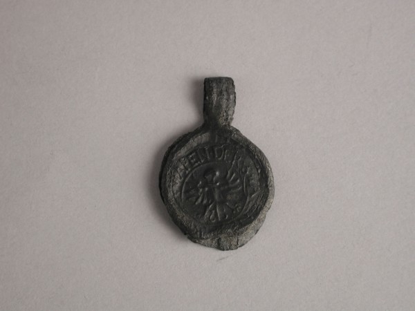 Sheet of cloth with text from Neuruppin, subprocessor lead pinned-red cloth seal hallmark ground find lead metal, Cloth bobbin