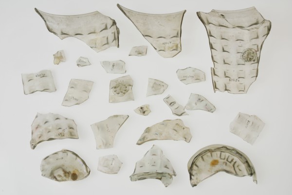 Fragments of soil, stand ring, wall and bramble decoration of waffle cup, beaker tableware holder fragment soil found glass