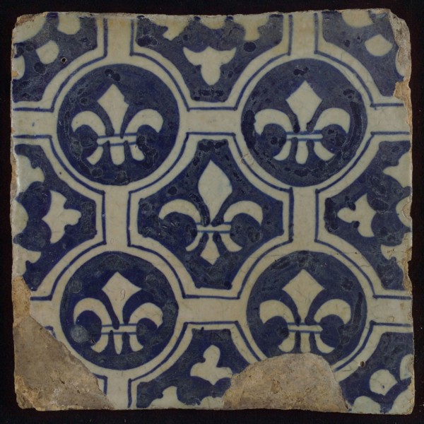Two-tone tile, blue on white background, four circles with white French lily around central ornament with lily, wall tile