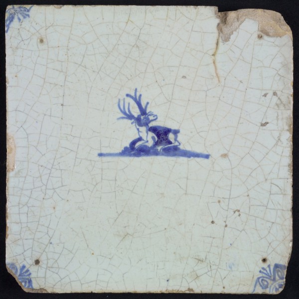 Animal tile with lying deer, small and blue decor on white ground, corner filling ox's head, wall tile tile sculpture ceramic