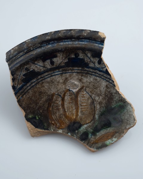 Fragment of majolica dish, polychrome three-tier or flower vase in the mirror, plate crockery holder soil find ceramic