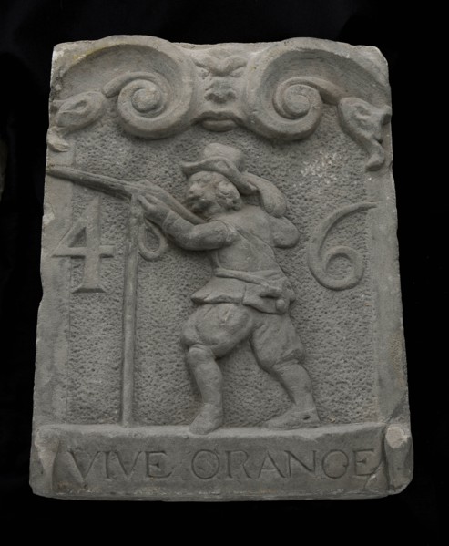Facade stone from gate with musketeer and ribbon with text vive orange 46, facing stone sculpture sculpture building component