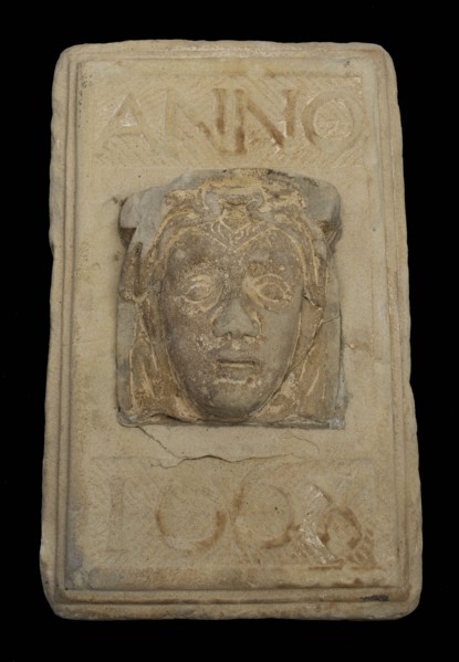 Facing brick with woman's head and text in 1668, facing stone sculpture sculpture building component sandstone stone, sculpted
