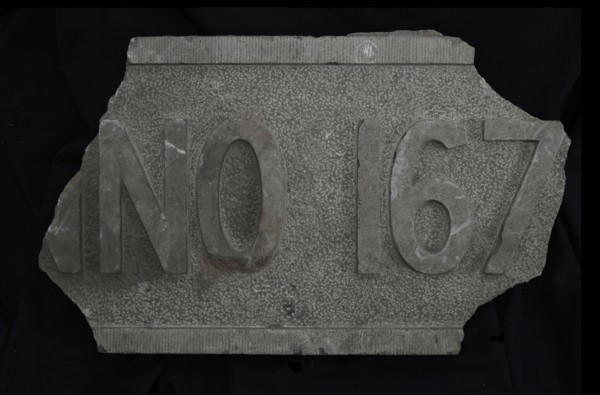 Fragment of facing brick with text ... NO 167 .., facing brick foundation stone building part stone, chopped rectangular frame