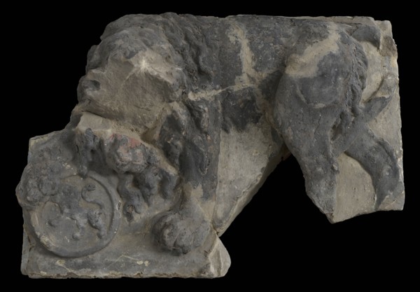 Fragment of facing brick, lion resting on tons, on which lion, facade stone sculpture sculpture building component sandstone
