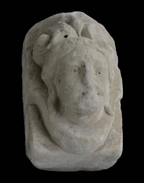 Console with woman's head, on top of double curl, console building element sandstone stone, sculpted