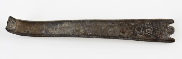 Broken flat handle of spoon, with two notches at the end, spoon cutlery soil find tin metal, cast Flat handle with round tip