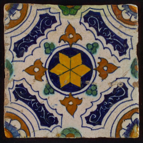 Tile, blue, green, brown and yellow on white, central yellow star in circle, sgraffito surfaces, corner motif, quarter rosette