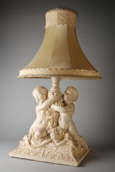 Simon Miedema, White table lamp, with decorated plaster foot of two putti and lampshade trimmed with lace, table lamp lamp