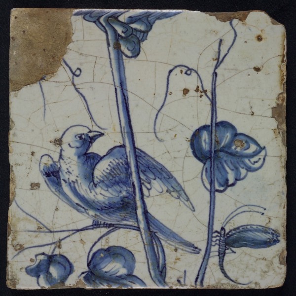 Blue tile with looking bird to dragonfly, on grape leaf of chimney pilaster with 13 tiles, tile pilaster footage fragment earth