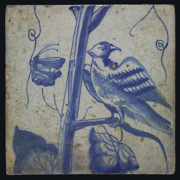Blue tile with looking bird on grape leaf, butterfly, of chimney pilaster with 13 tiles, tree of bunches of grapes with birds