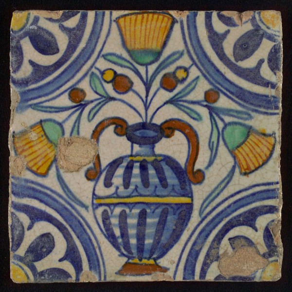 Tile, blue draft, orange, brown, yellow and green on white, central flowerpot with marigolds, corner pattern, rosette, wall tile