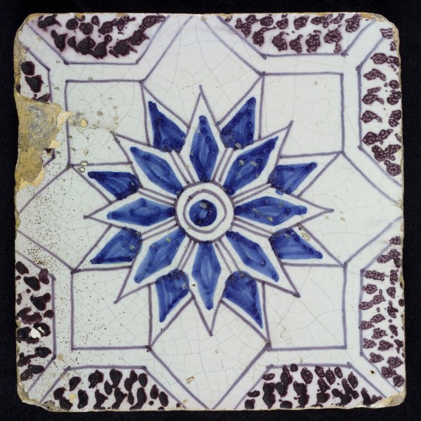 Sprinkled ornament tile, center double circle, double eight-pointed blue star, against background of two white eight-pointed