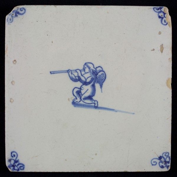 White tile with blue kneeling putto with wind instrument, corner motif spider, wall tile tile sculpture ceramic earthenware