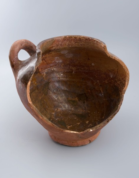 Fragment of pottery storage pot on stand, lying sausage ear, storage jar pot holder soil find ceramic earthenware glaze lead